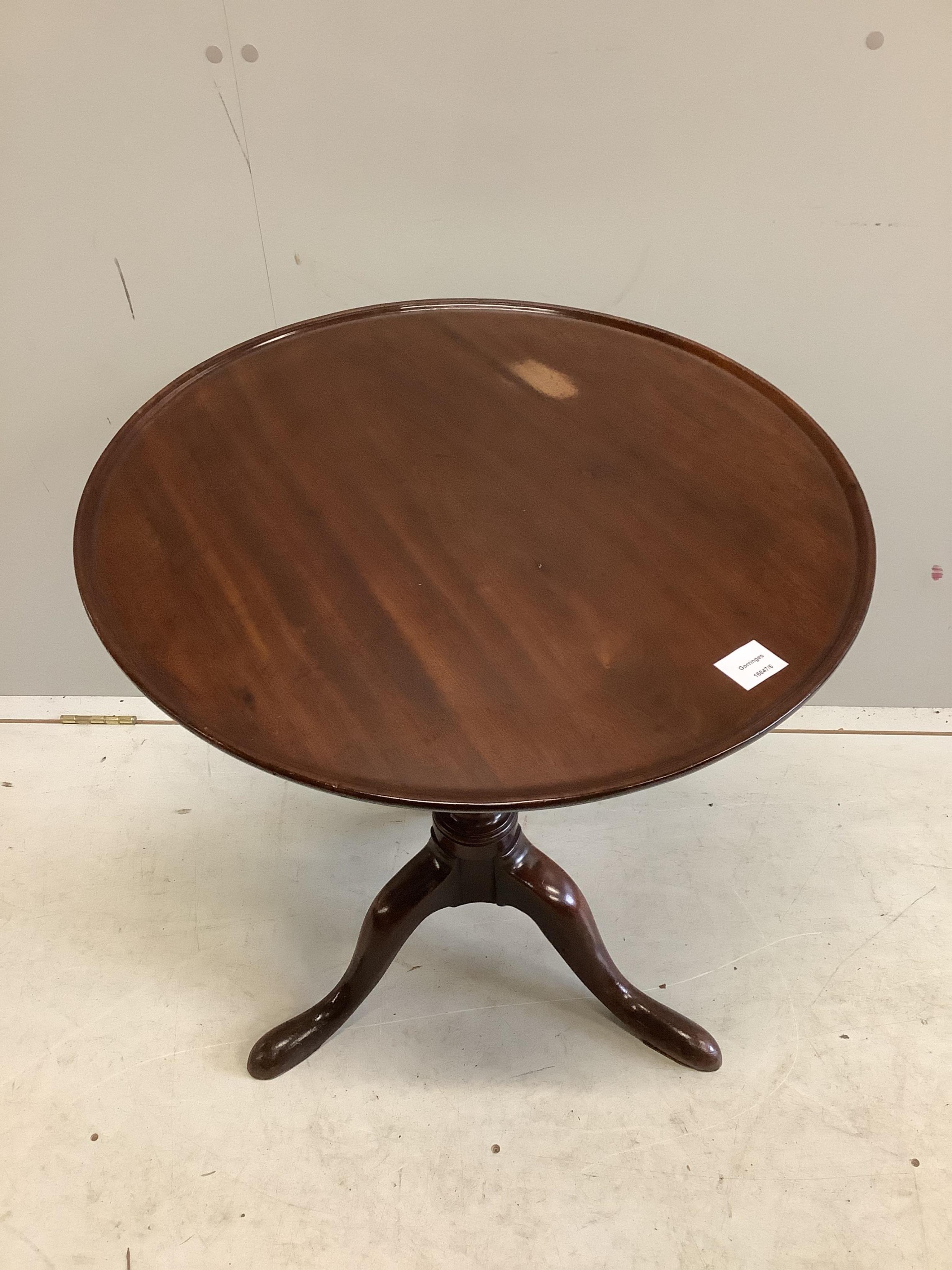 A George III circular mahogany tilt top tripod tea table, diameter 63cm, height 69cm. Condition - fair